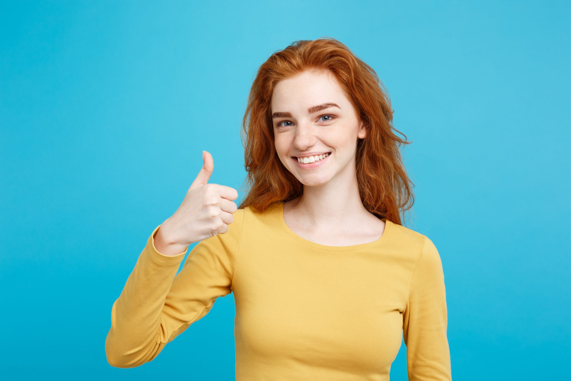Elyxa Australian Organic Whole-food Supplements Portrait Of Young Stylish Freckled Girl Laughing With Showing Thumps Up At Camera. Copy Space.