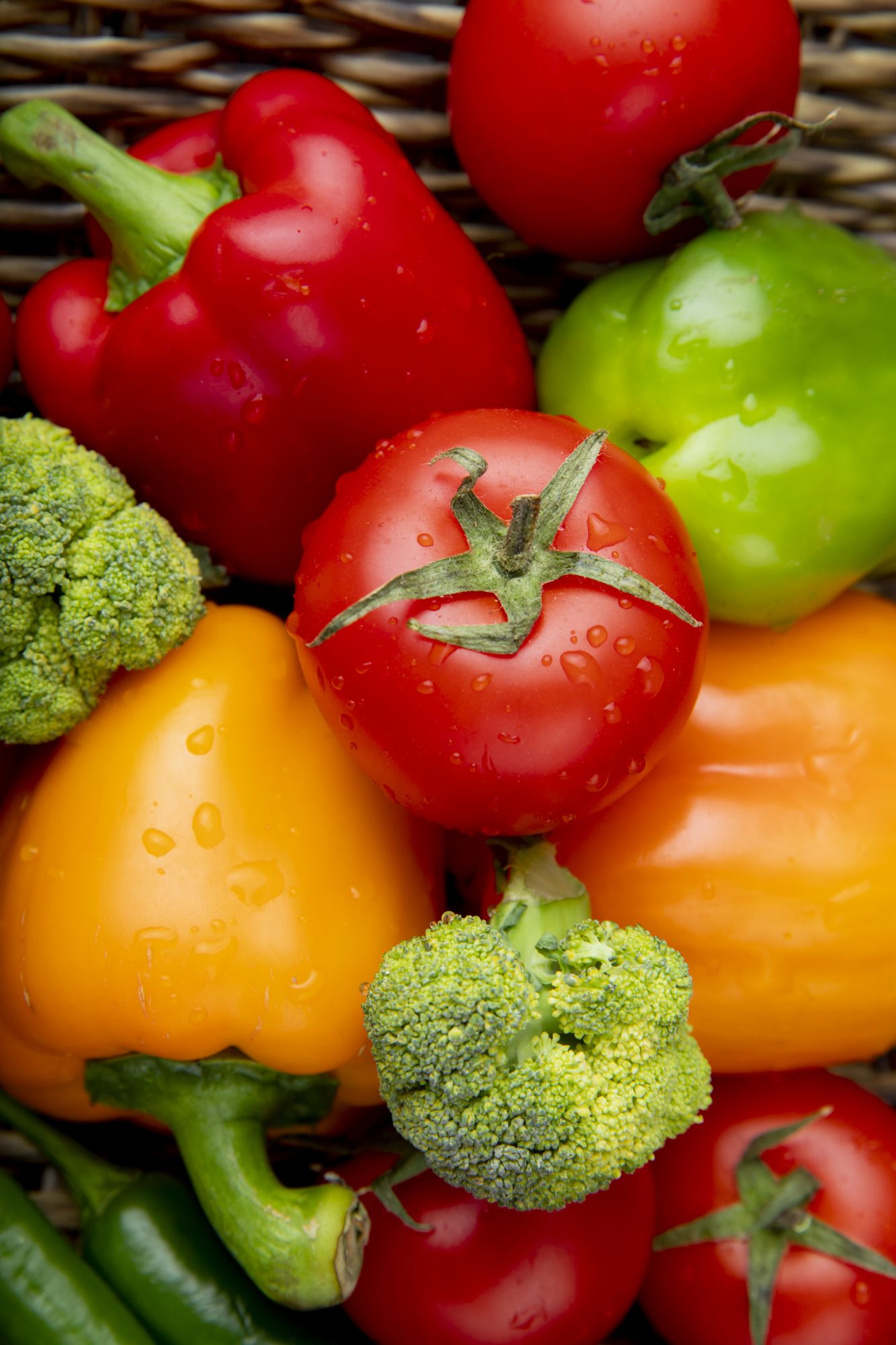 Elyxa Australian Organic Whole-food Supplements Vegetables As Peppers Tomatoes And Broccoli On Wicker Surface Top View